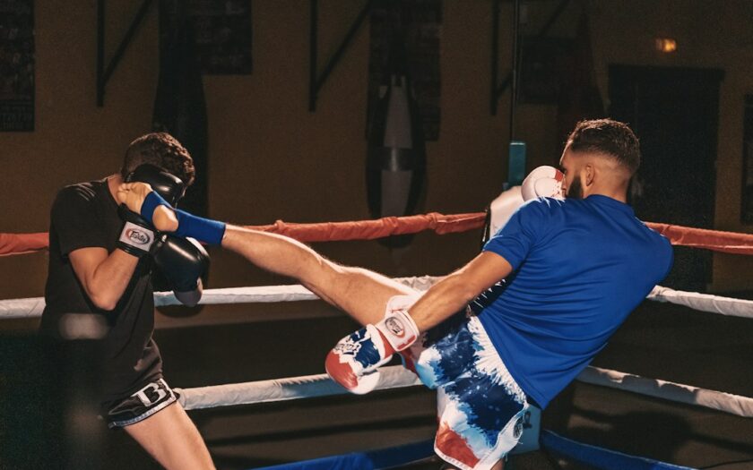 2 men in blue t-shirt and white shorts doing exercise